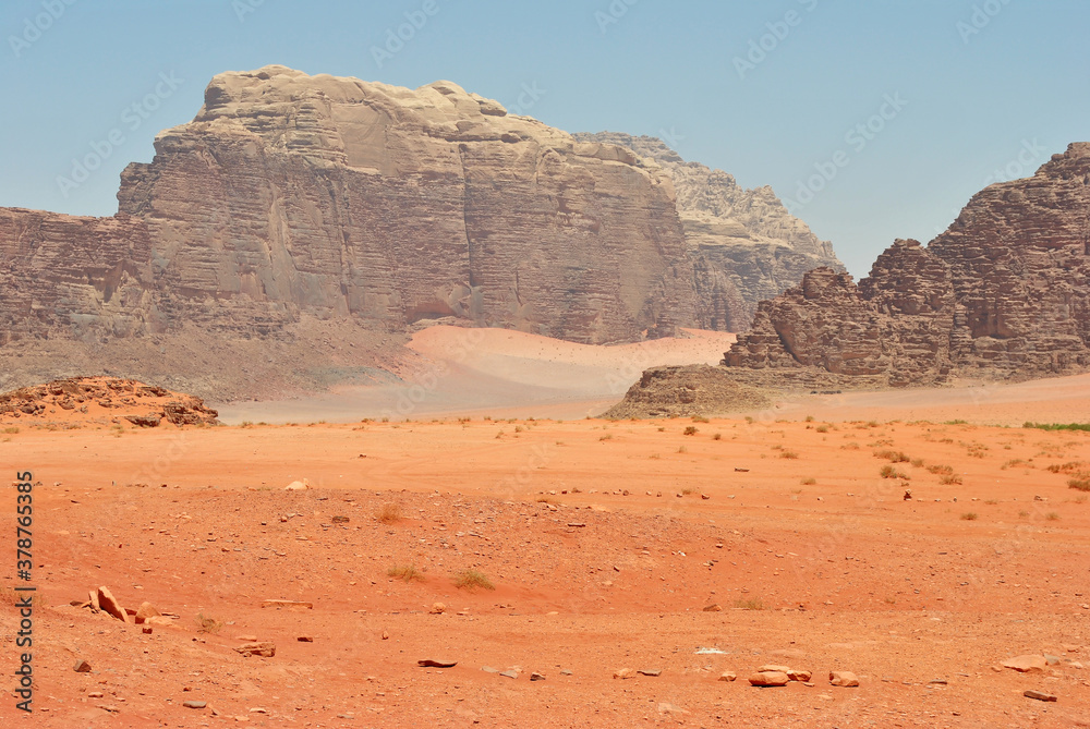 Giant sandstone rocks and orange sand of the desert