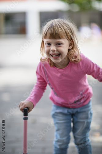 Smiling happy little girl walking on crutches