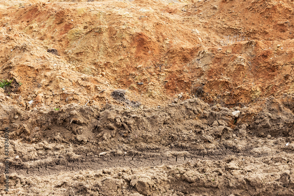 Red soil earth texture background realistic closeup background. Texture of land dried up by drought. Red soil earth texture background realistic closeup background. Texture of land dried up by drought.