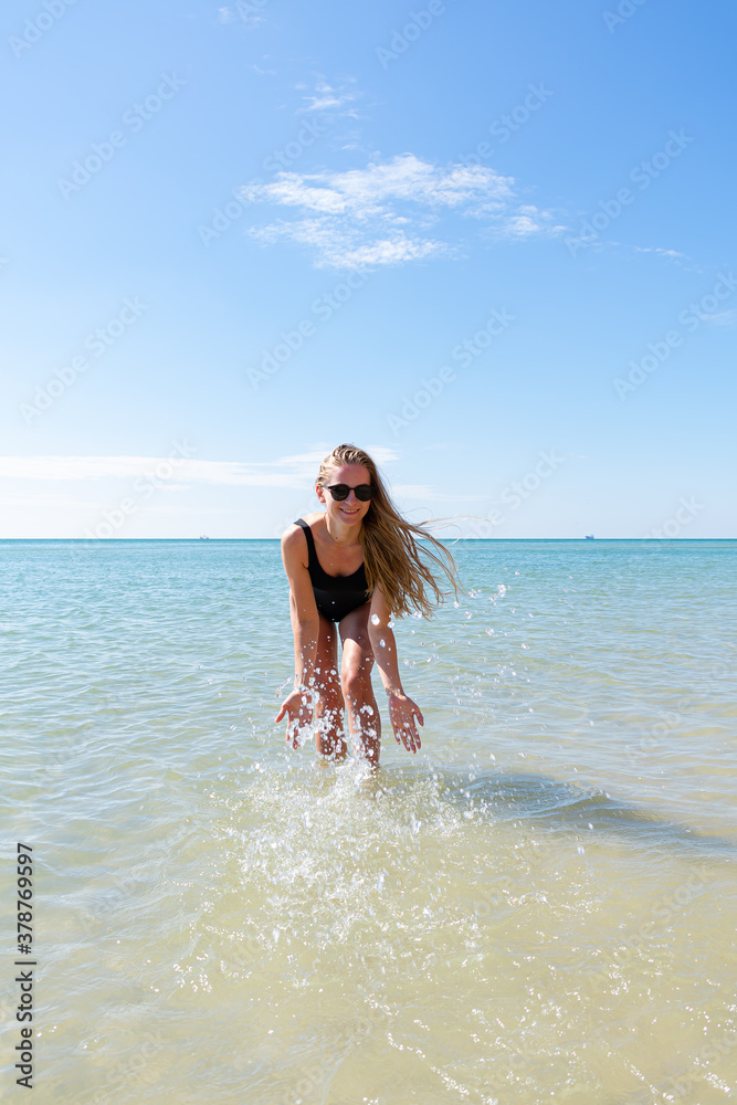 Woman enjoying her holidays at the tropical beach. Happy young woman enjoys her beach vacation Woman enjoying her holidays at the tropical beach. Happy young woman enjoys her beach vacation
