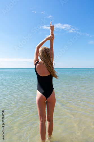 Woman enjoying her holidays at the tropical beach. Happy young woman enjoys her beach vacation