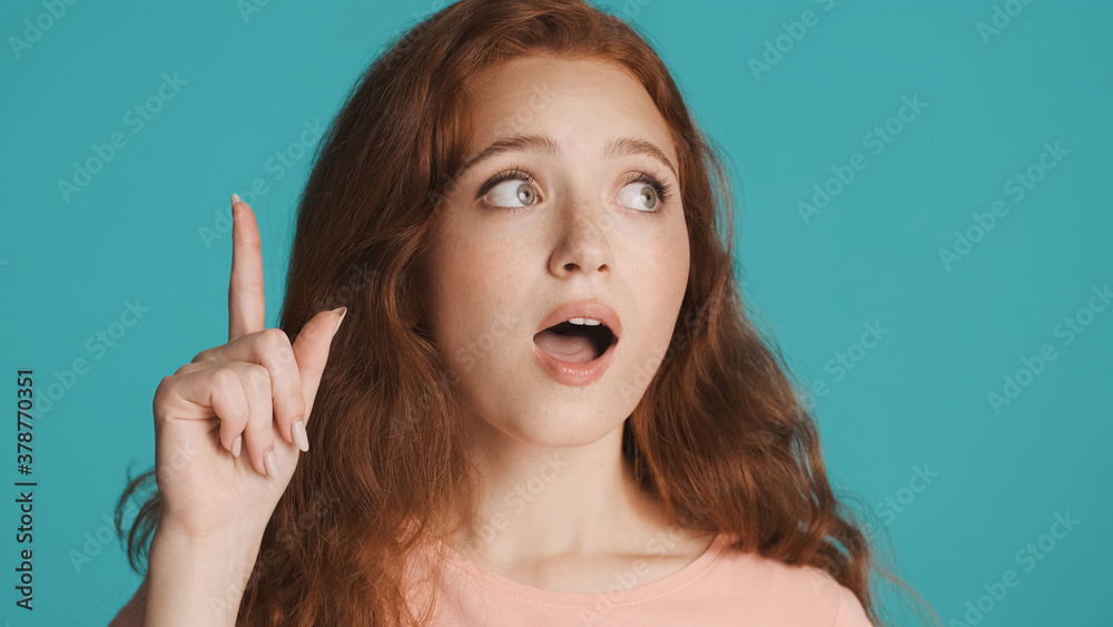Close up excited girl showing new idea gesture on camera over colorful background. Wow expression Close up excited girl showing new idea gesture on camera over colorful background. Wow expression