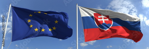 Photos Waving flags of the European Union and Slovakia on flagpoles, 3d rendering