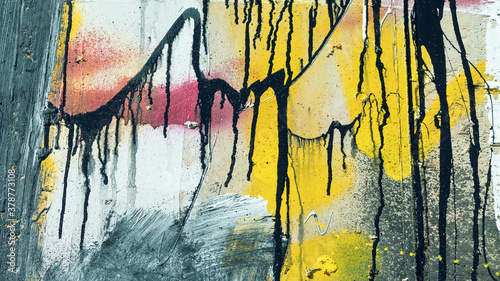 Rough paint dripping, spray paint artwork. Abstract background oil paint painting style. Damage to walls with many colors. Rough concrete surface with cracks, scratches and paint stains