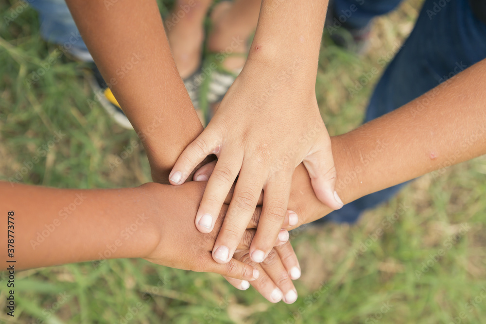 different race boys group of hands together as agreement or start up in a natural place and view from above different race boys group of hands together as agreement or start up in a natural place and view from above