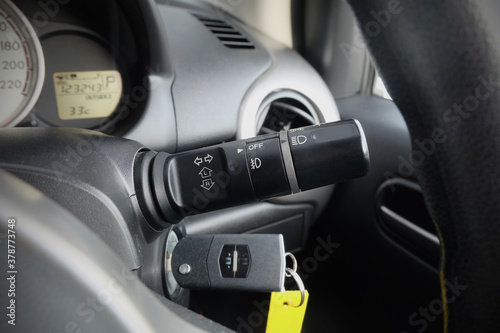 Switch off lights in a car. close-up Car integrated turning indicator with headlight switch toggle. © Muanpare