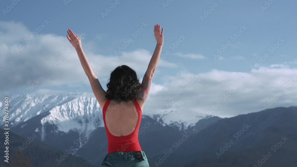 Woman with hands up in front of a winter landscape Woman with hands up in front of a winter landscape