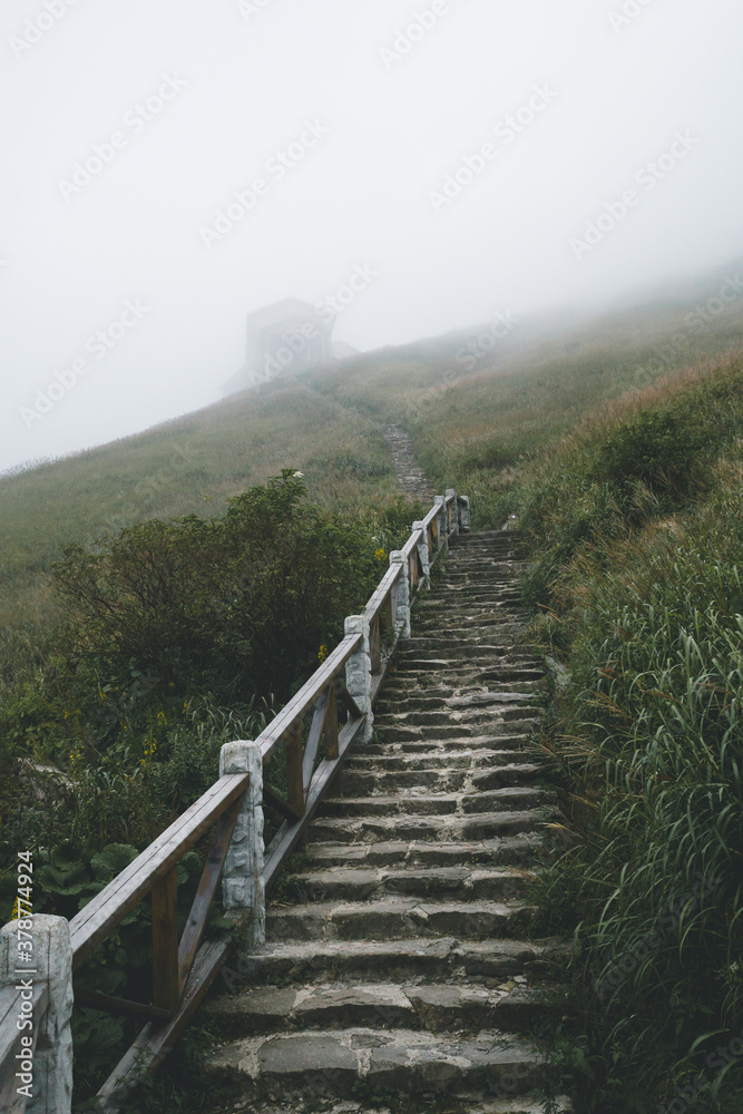 Steps leading to house in fog on Wugong Mountain in Jiangxi, China