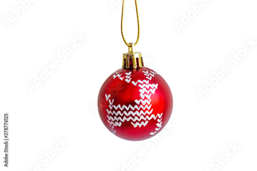 Red Christmas bauble with a white pattern of a deer isolated on white. Christmas ball hanging on a golden string.