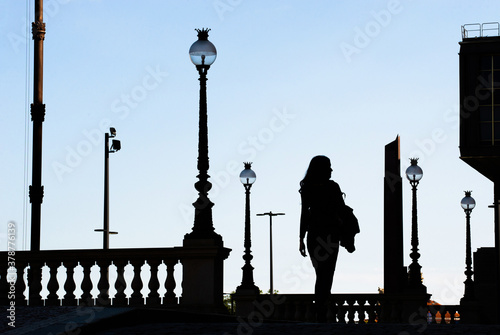 Woman is walking in front National Museum. City background with lamps