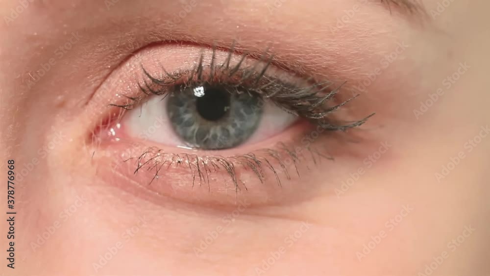 Macro video of woman blue eye. Macro close up of beautiful caucasian woman opening and closing blue eye with eyelashes . High quality FullHD footage Macro video of woman blue eye. Macro close up of beautiful caucasian woman opening and closing blue eye with eyelashes . High quality FullHD footage