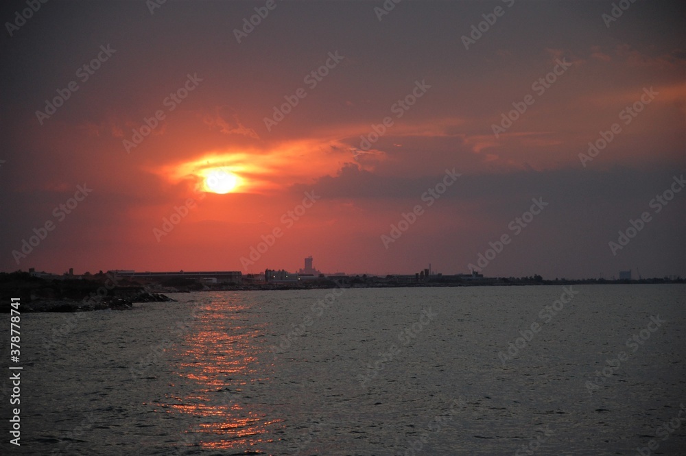 red sunset light over the sea and the town of Trani in Puglia in Souther Italy