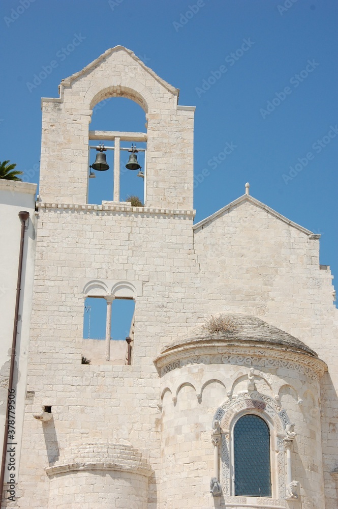 The white stone church called Ognissanti in the town of Trani in Puglia and a clear blue summer sky above