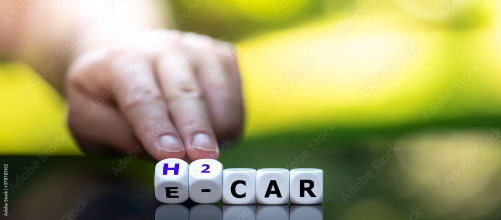 Electric car or a hydrogen car? Hand turns dice and changes the expression 