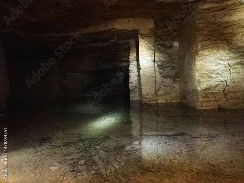 Descent to the catacomb, dungeon, view of the tunnel going down. Katakombs Secrets of underground Odessa Ukraina photo