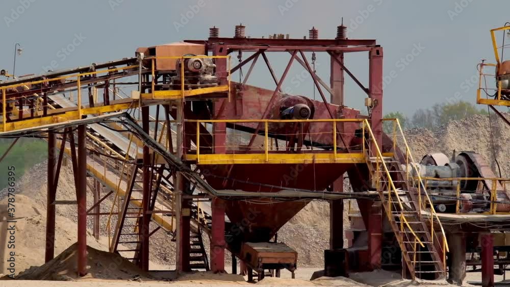 Stone crusher plant machine. Conveyor belt in work process. Transportation and separation of gravel pebbles. Quarry equipment for production of building materials. Stone crusher plant machine. Conveyor belt in work process. Transportation and separation of gravel pebbles. Quarry equipment for production of building materials.