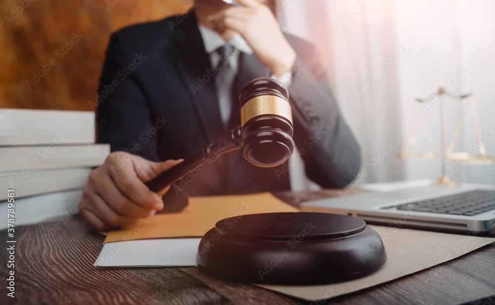 Business and lawyers discussing contract papers with brass scale on desk in office. Law, legal services, advice, justice and law concept picture with film grain effect