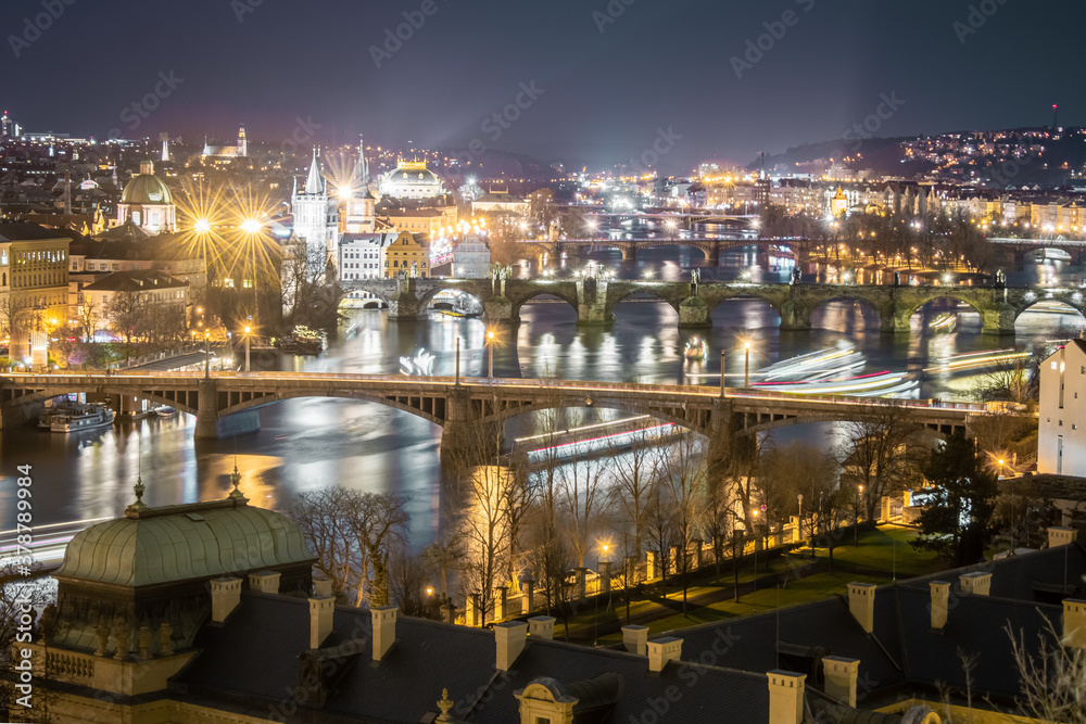 famous view of Prague bridges  over the Vltava river in winter, Charles bridge, and national theater, long exposure night photo
