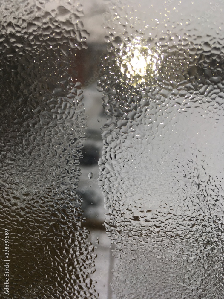 view from the window wet glass covered with wet flowing water, snow melts view from the window wet glass covered with wet flowing water, snow melts