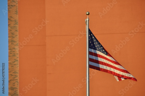 American Flag Against Orange Wall
