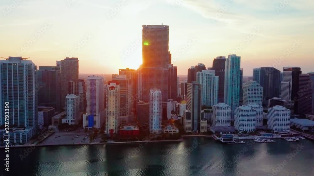 Aerial view of the highrise buildings, in the Brickell cityscape, during sunrise, in Miami, Florida, USA - tracking, drone shot Aerial view of the highrise buildings, in the Brickell cityscape, during sunrise, in Miami, Florida, USA - tracking, drone shot