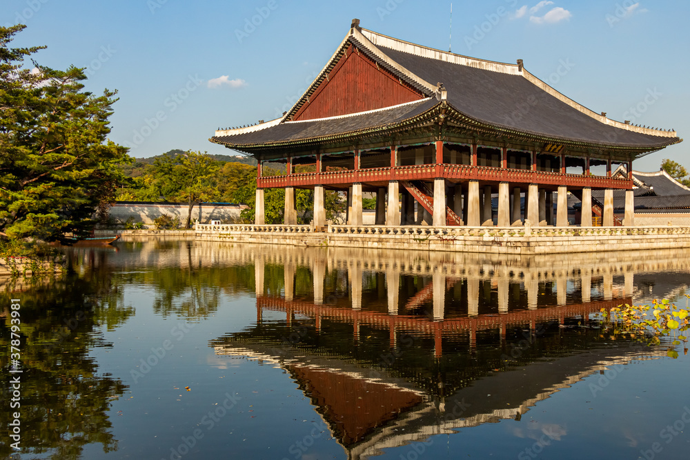 A building of Korean architecture reflecting on a lake at Gyeongbokgung Palace A building of Korean architecture reflecting on a lake at Gyeongbokgung Palace