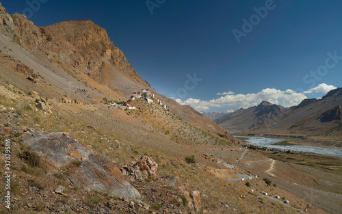 Off road view of Key monastery flanked by Himalayas and Spiti river, Kaza, India.