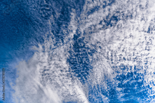 фотографія Many altocumulus clouds on blue sky.