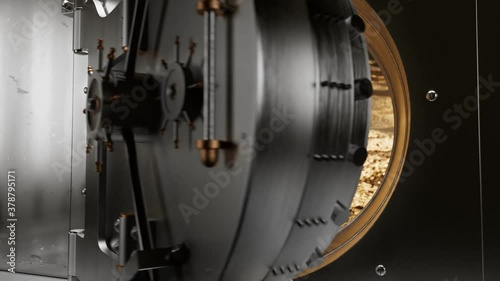 The huge metal treasury door opens. The vault is full of golden coins. Security photo