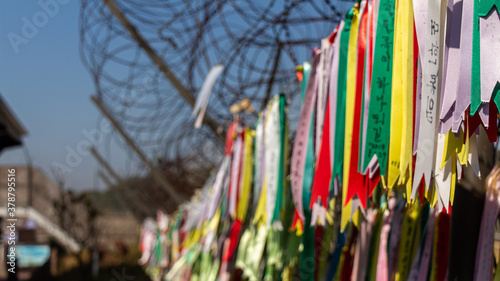Photography Prayer ribbons attached to a barb wire fence at the Korean Demilitarized Zone