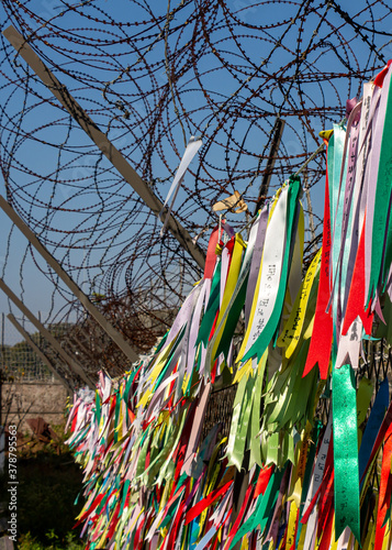 Prayer ribbons attached to a barb wire fence at the Korean Demilitarized Zone photo