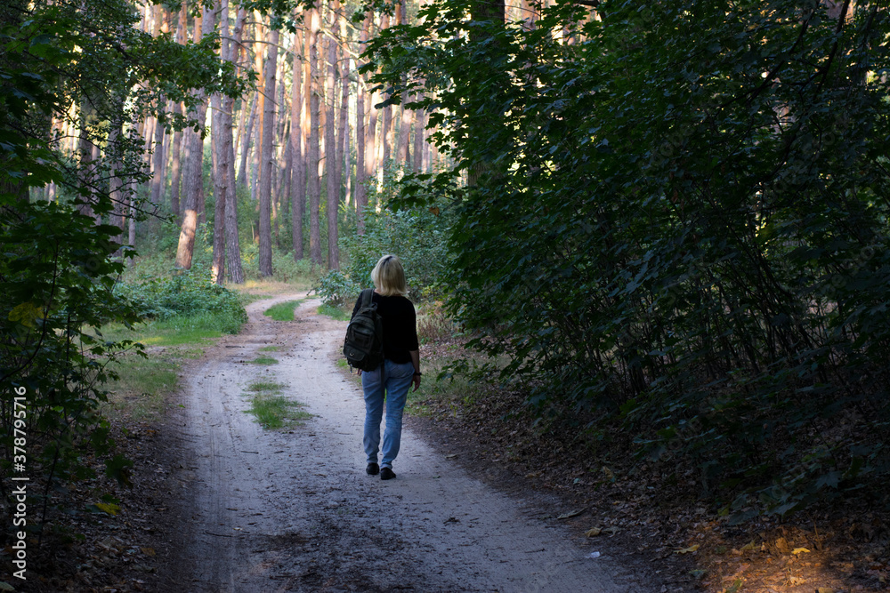 girl walking in the woods back view
girl walking in the woods back view