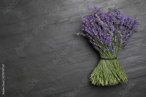Fototapeta Naklejka Na Ścianę i Meble -  Beautiful lavender bouquet on black background, top view. Space for text