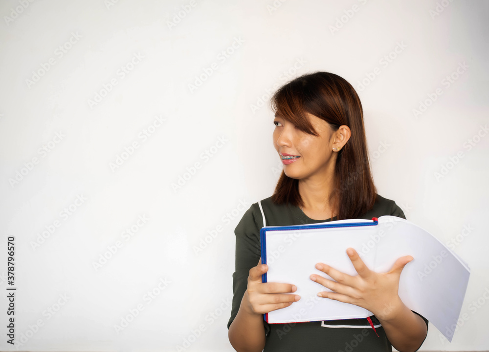 Lady wearing braces.holding book in hand,looking to the left side and smile,model posing Lady wearing braces.holding book in hand,looking to the left side and smile,model posing