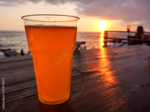 Glass with beer on the table by the sea