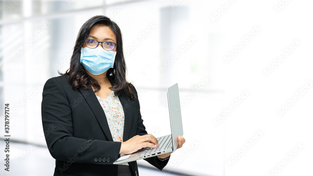 Asian lady wearing mask new normal in office for protect safety infection Covid-19 Coronavirus. Asian lady wearing mask new normal in office for protect safety infection Covid-19 Coronavirus.