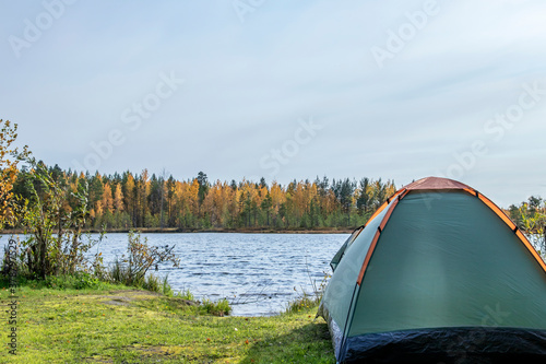 Tourism. Tent by the lake. Autumn landscape.