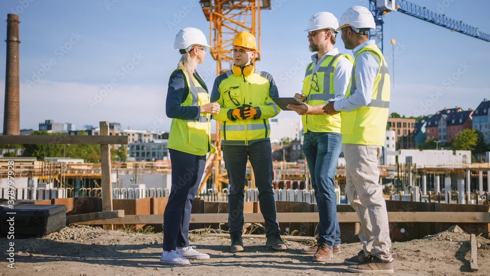 Diverse Team of Specialists Use Tablet Computer on Construction Site. Real Estate Building Project with Civil Engineer, Architect, Business Investor and General Worker Discussing Plan Details. Diverse Team of Specialists Use Tablet Computer on Construction Site. Real Estate Building Project with Civil Engineer, Architect, Business Investor and General Worker Discussing Plan Details.
