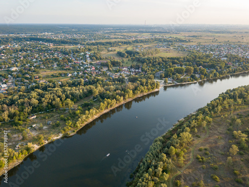 Aerial drone view. The bend of a wide river among green meadows. Sunny summer day. © Sergey