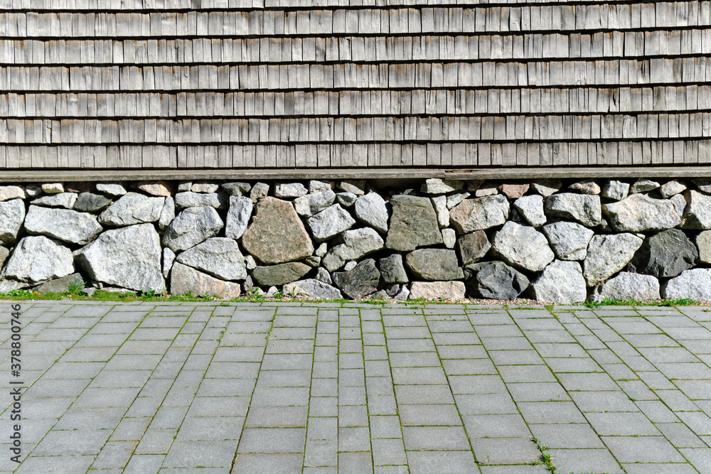 The wooden wall of the building.