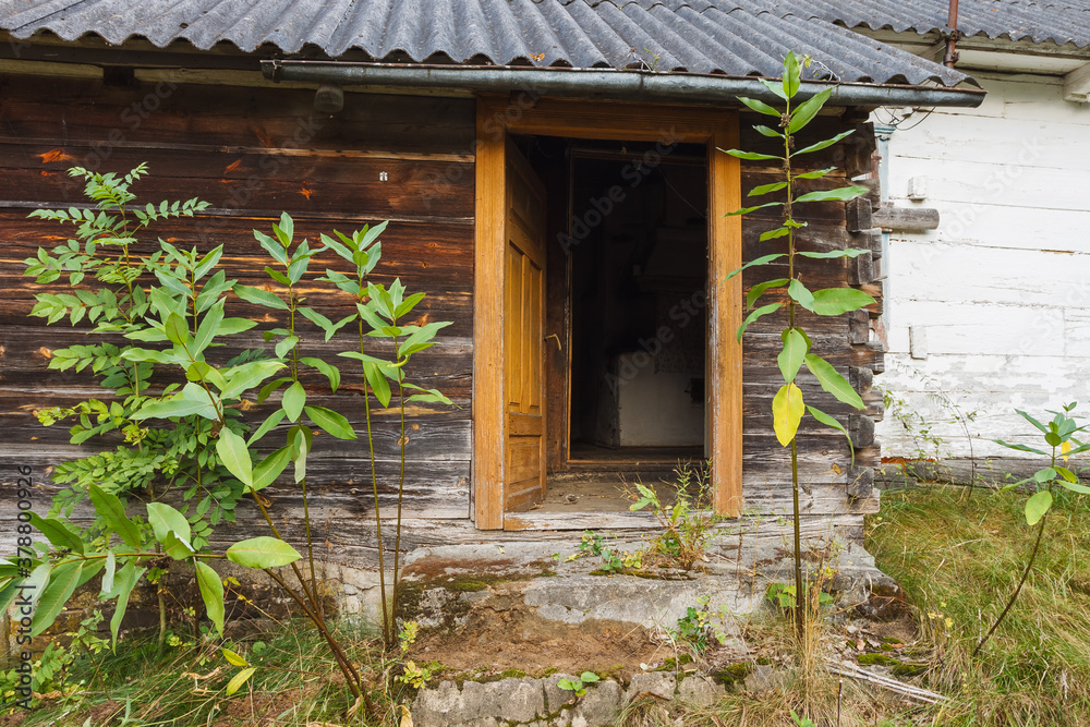 Open door to an old wooden house