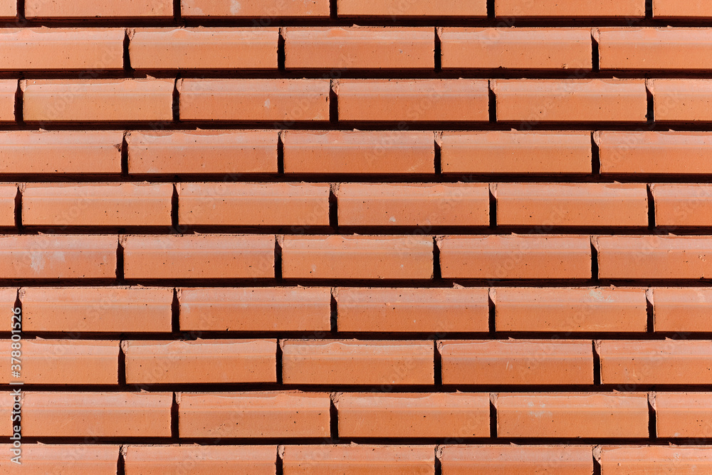 The modern brick facade wall of the building.