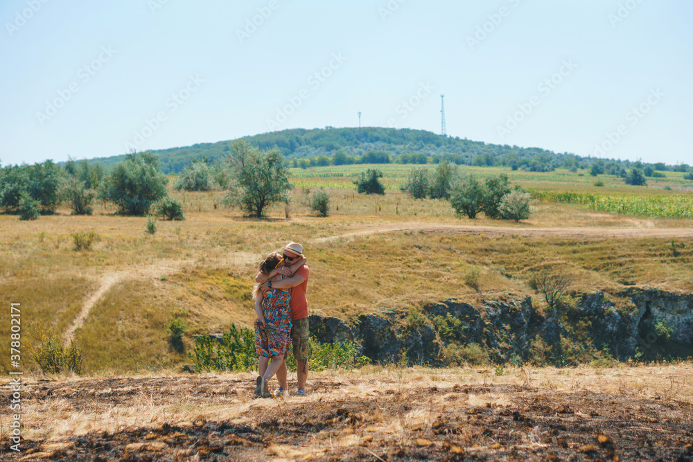hugging couple on sunny hill