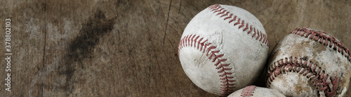 Baseball balls on wood background for sports banner.