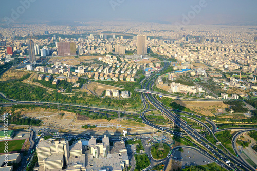 View of the city, highway and surrounding houses from the Milad Tower (Borj-e Milad) in Tehran. Milad Tower is the most important monument of Tehran after the Azadi Monument. Shadow of the tower.