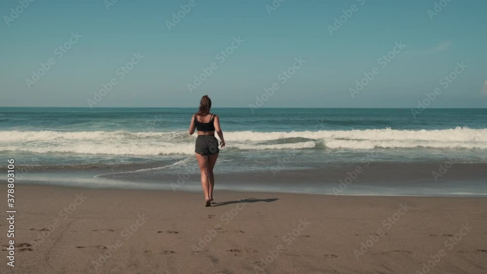 jogger is enjoying jogging on ocean beach jogger is enjoying jogging on ocean beach