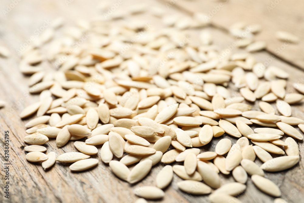 Raw cucumber seeds on wooden background, closeup. Vegetable planting Raw cucumber seeds on wooden background, closeup. Vegetable planting