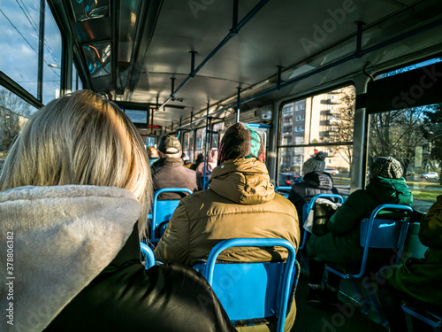 Blurred image of people sitting inside public transport wagon on move. Passengers.