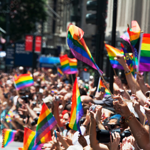 People carrying rainbow flags in gay pride parade, New York City, New York State, USA