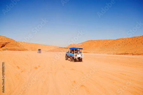 Vehicle moving through an arid landscape, Antelope Canyon, Page, Arizona, USA